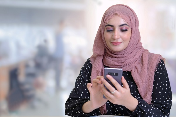 Woman using mobile phone online