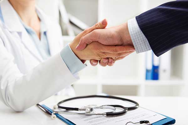 Doctor shaking hands with a business man