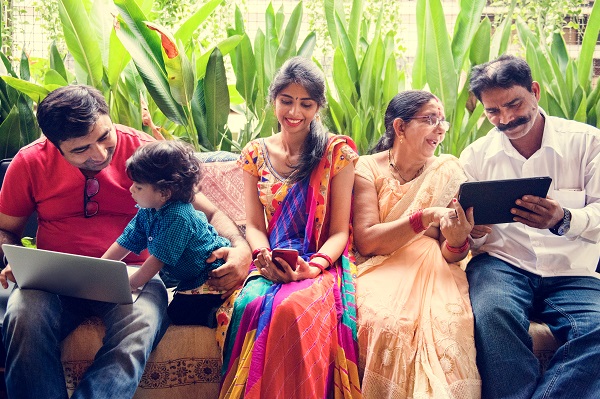 Family of 3 generations showing each other information on mobile tablets